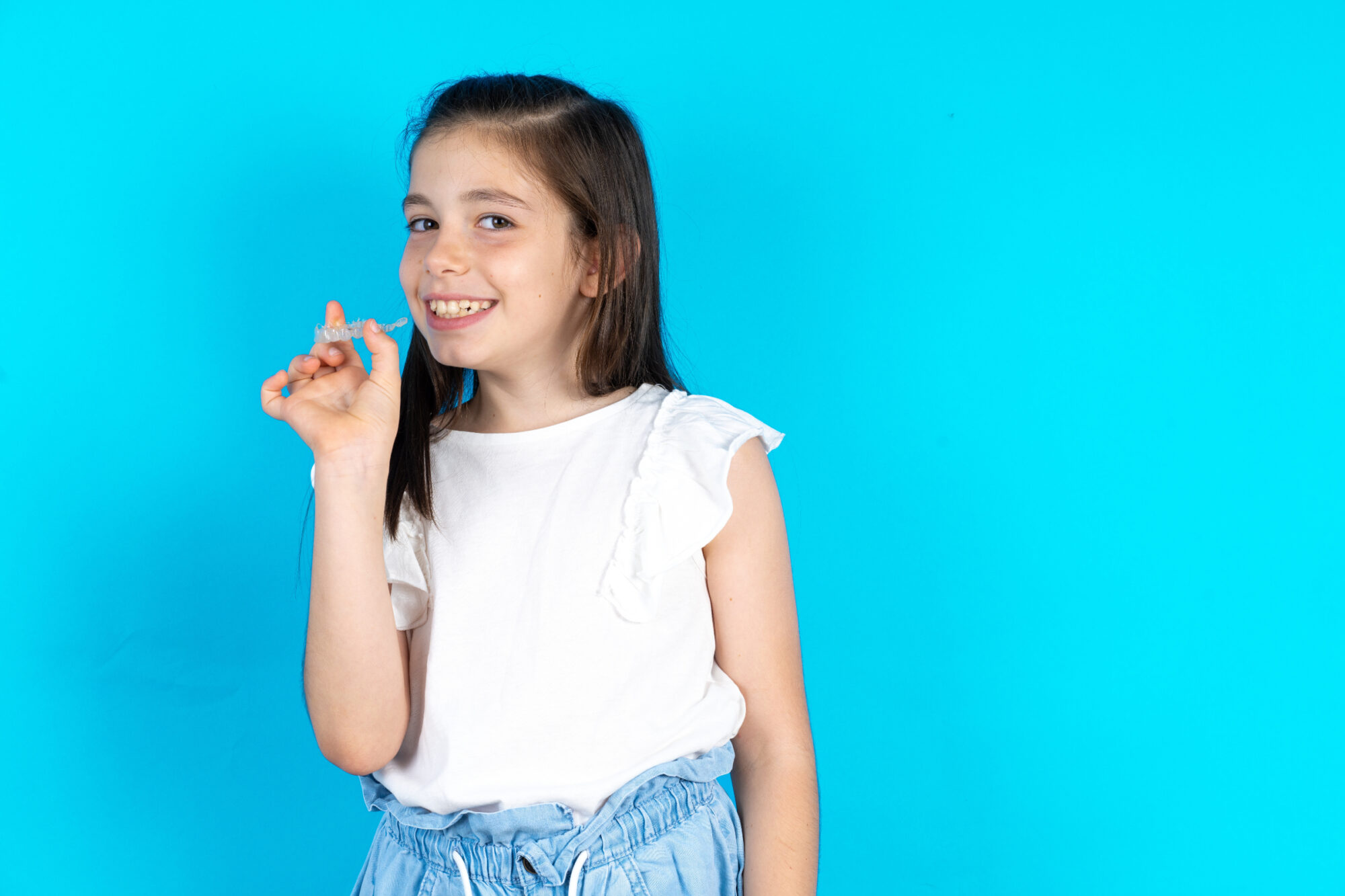 child with clear aligners